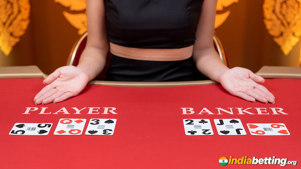 online casino baccarat table with dealt cards